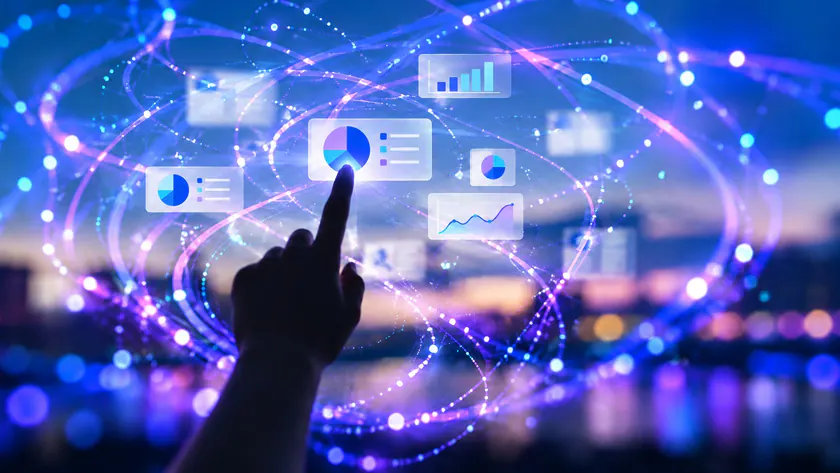 A hand interacting with luminous pie charts and data graphics in blue and violet