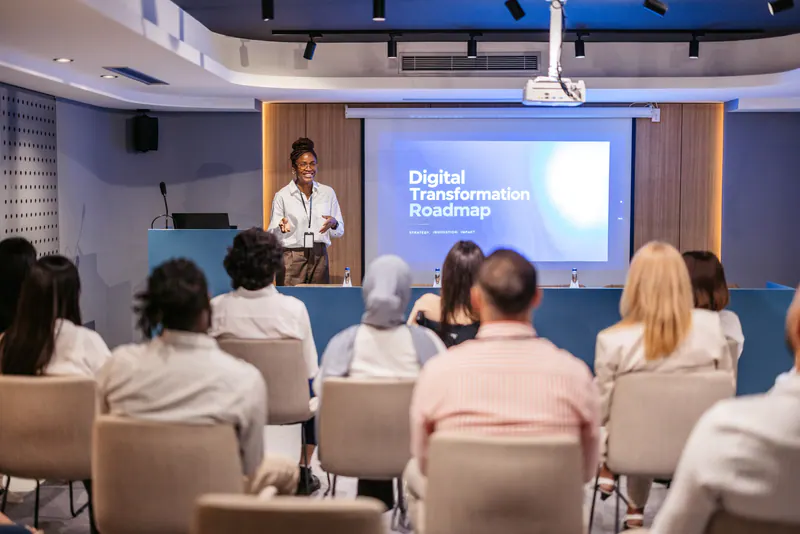 A presenter explaining a digital transformation roadmap to an audience